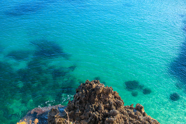 Typical coastline near Monopoli : high and rocky coast characterized by small sandy coves with cliffs, rocky arches and sea caves.