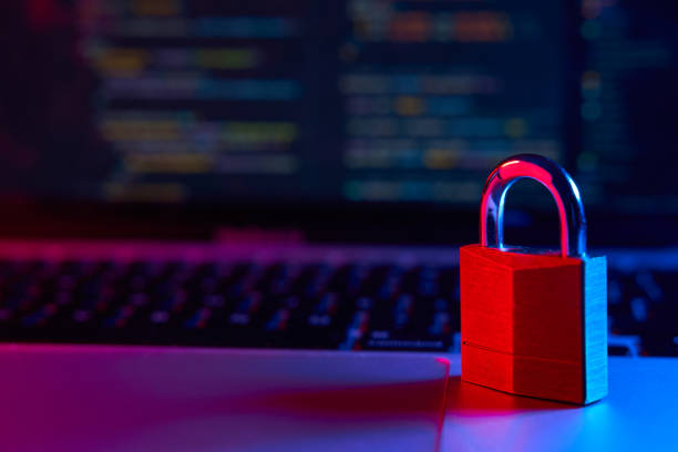 istock Internet security concept. Lock over laptop with code in the background lit with blue and red lights 1952529610
