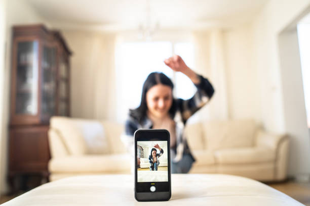 istock Woman at home dancing while recording content for social media 1952536015