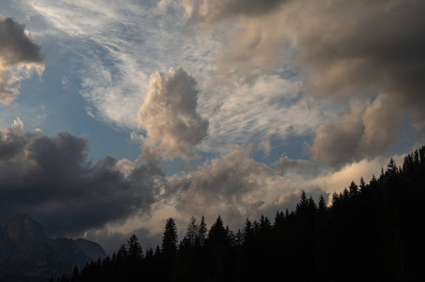 Mount Catinaccio range covered by clouds seen by Pozza di Fassa, Val di Fassa, Dolomites