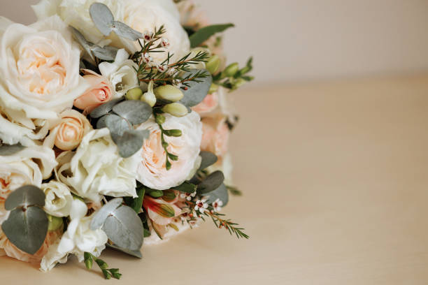 istock Wedding bouquet of white roses with beige copy space 1952569885