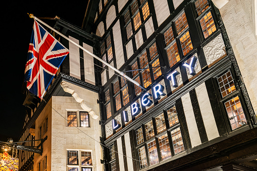 Bristish flag and Libery sign at the entrance of the building famous department store in London, UK