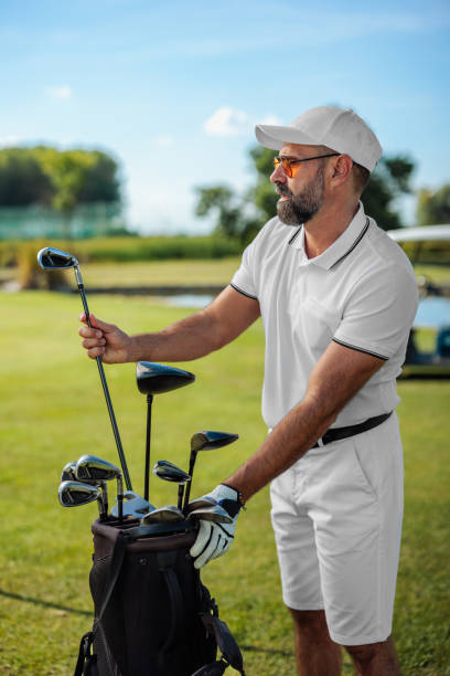 istock A golf specialist selects his gold clubs 1952583541