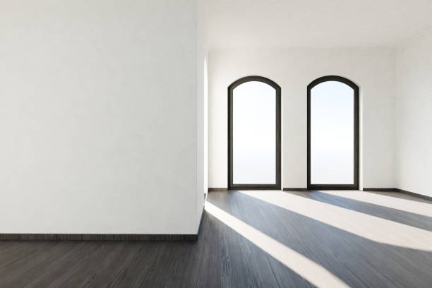 istock frontal view on empty luxurious loft apartment with floor-to-ceiling windows and panoramic view; modern minimalistic interior design; bright daylight; 3D rendering 1952587847
