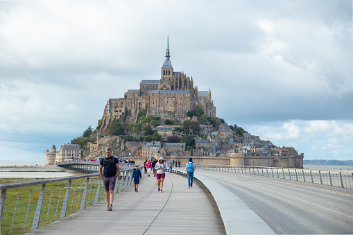 Normandy, France –Aug 29,2023: Tourists walking in front of the Mont Saint-Michel
