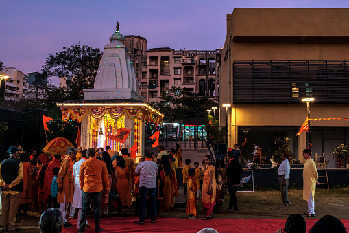 Pune, India - January 22 2024: Devotees celebrate the inauguration of Ram Temple at Ayodhya at a well lit Temple at a residential society at Pune India.