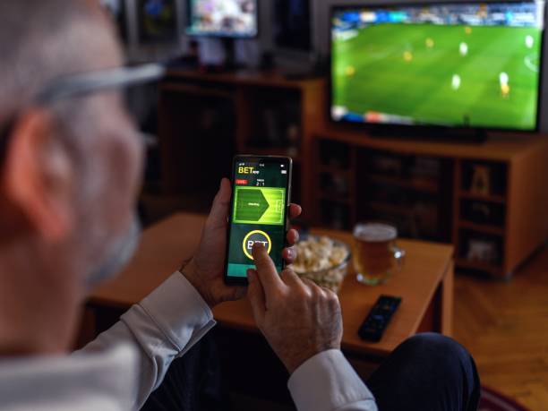 istock Mature men using smart phone for sports betting. 1952622342