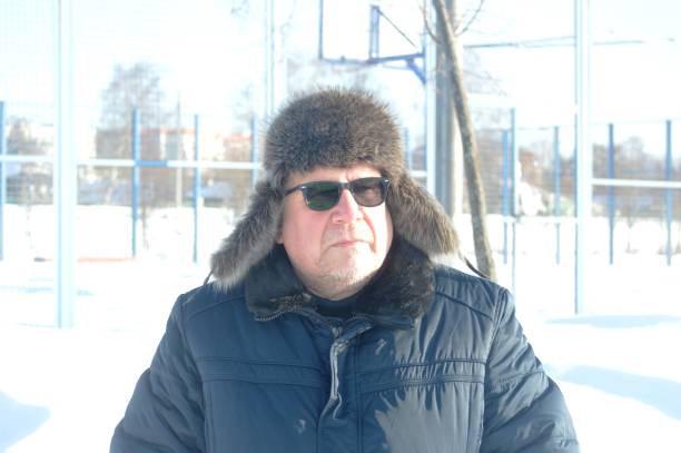 portrait of a male fashion model wearing winter hats and warm jackets