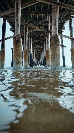 A view of the underside of the pier at Newport on a stormy day