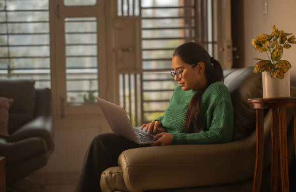 istock Woman using laptop working at home 1952640328