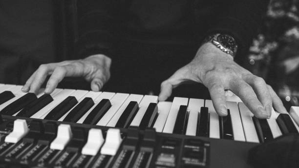 istock Hands playing an electronic keyboard in black and white 1952647147