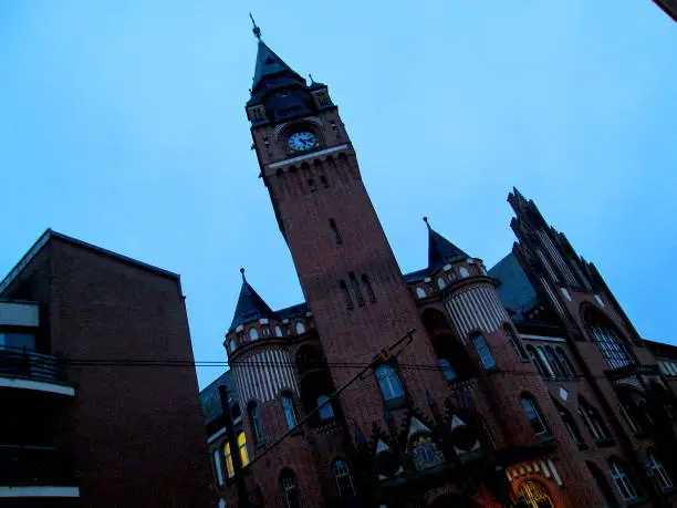 Berlin Koepenick Old Town Winter Cloudy Blue Twilight Old Buildings Lit-up and the Brick Clock Tower Silhouette