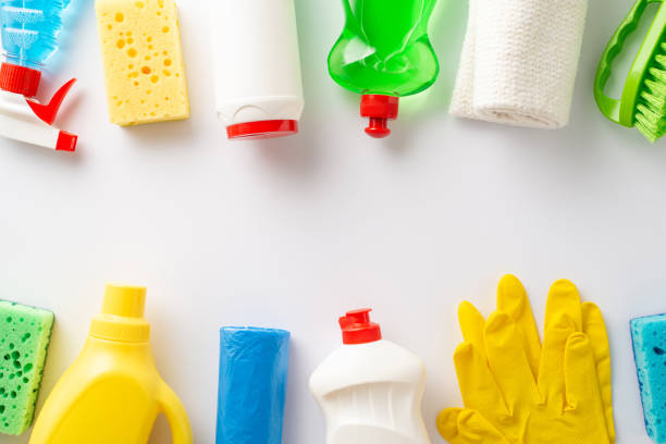 istock Sanitizing with disinfectant essentials idea. Top view cleaning cloths, scrubbers, latex gloves, scrub brush, cleaning solution bottles, sanitizer gel, spray bottle on blank surface for text or promo 1952671261