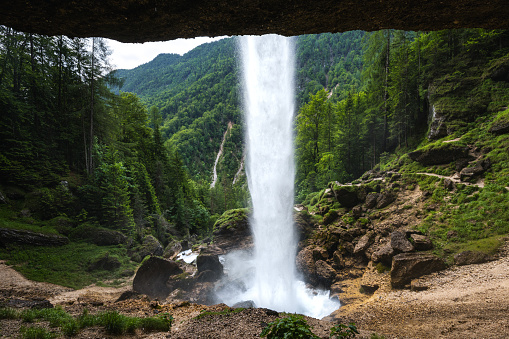 View on Pericnik waterfall from behind at Triglav national park in Slovenia.