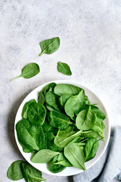 istock Fresh spinach leaves. Top view with copy space. 1952688126