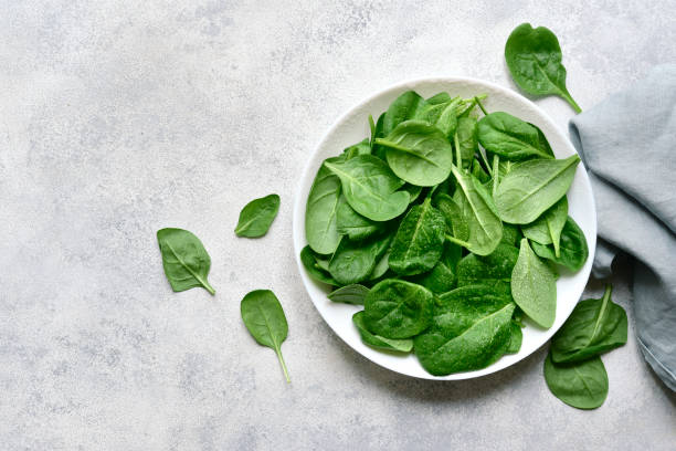 istock Fresh spinach leaves. Top view with copy space. 1952691888