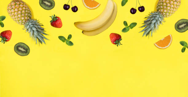 istock Fruit and berry on the yellow background. Copy space. Top view. 1952692449