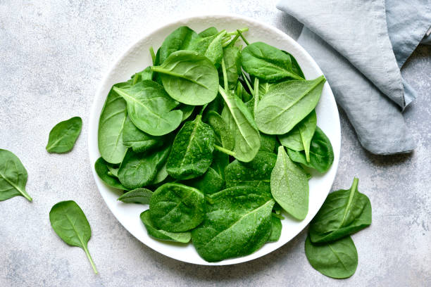 istock Fresh spinach leaves. Top view with copy space. 1952693438