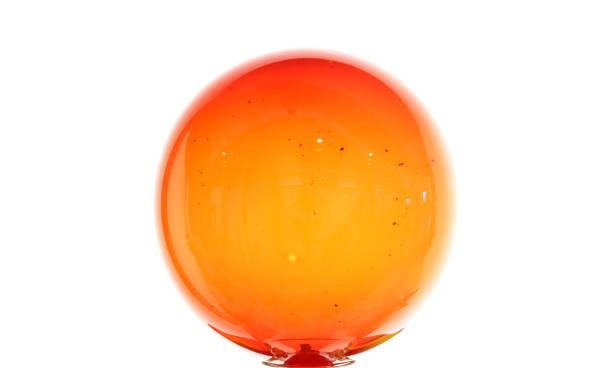 Abstract glass installation, red sphere isolated on white wall background