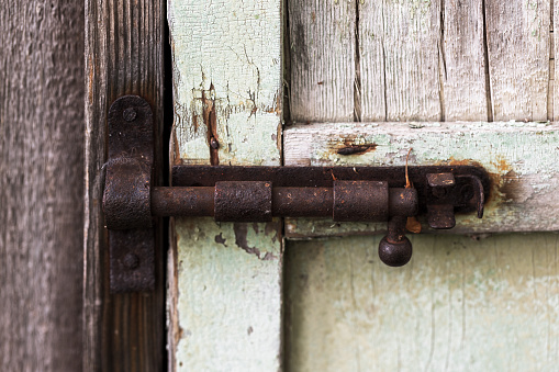 Closed old rusty door latch, close up photo