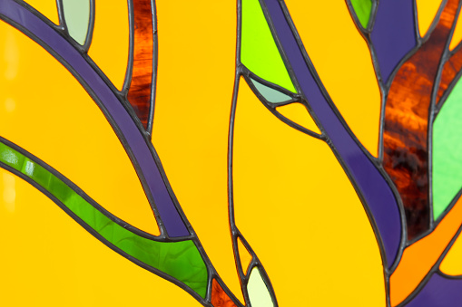 Colorful stained glass fragment, close up photo