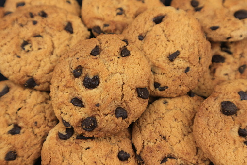 A plate of freshly baked chunky chocolate chip cookies.
