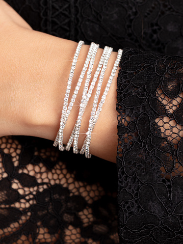 Close-up of a silver bracelet on a girl's hand.