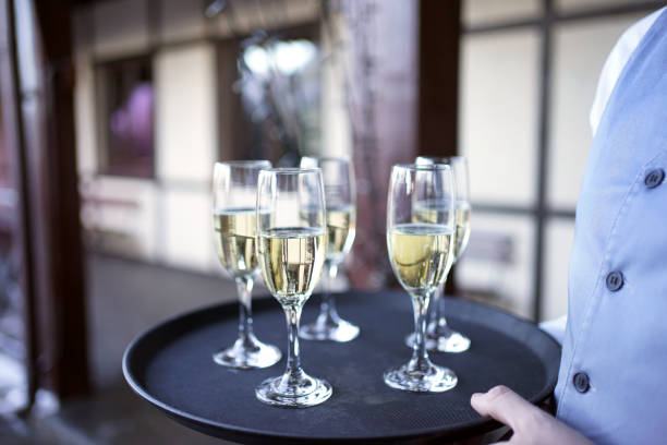 istock Several glasses filled with champagne are kept on a tray. 1952755843