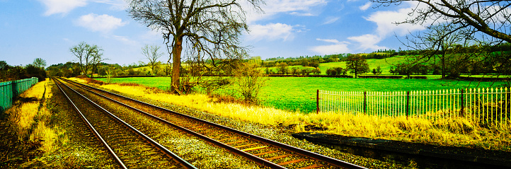 A station England UK. Diesel powered railway line in the English countryside. Station on a sunny day. Panoramic - Panorama.