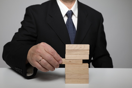 Businessman building blocks risk growth change insurance