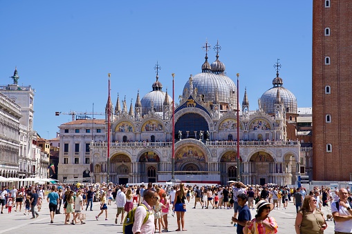Scenic view of famous Piazza san Marco with cathedral and campanile with crowd of tourists at City of Venice on a sunny summer day. Photo taken August the 7th, 2023, Venice, Italy.
