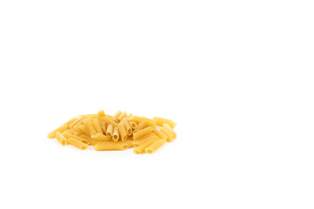 Close up of uncooked penne rigate pasta for background use. Dry macaroni noodles