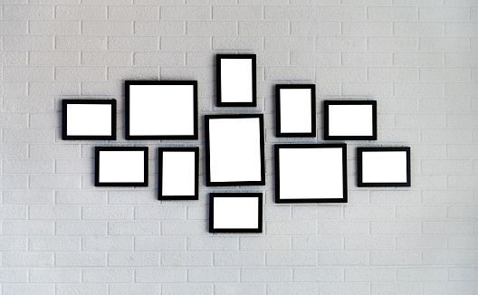 Empty picture frames on brick wall