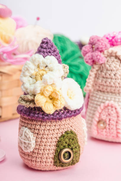 istock Handmade spring decor concept. Creative crocheting, house figurines, traditional flowers and stuff 1952864299