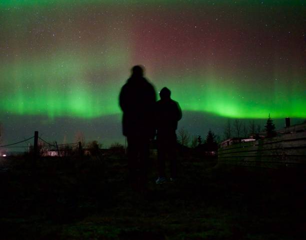 istock Two person in front of the Northern lights 1952864413