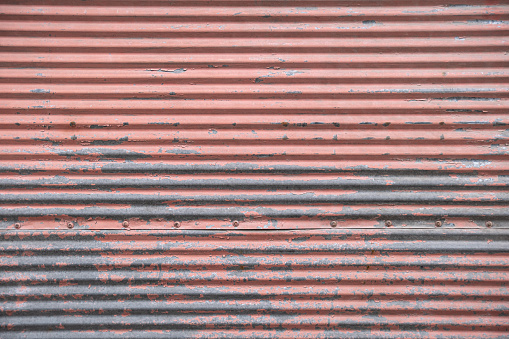 Old, worn and rusty corrugated metal surface.