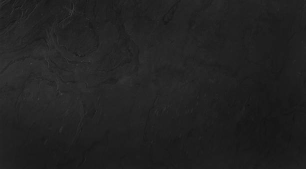 istock seamless grungy dark black concrete texture use as background. black stone wall background. gray grunge texture background with space for text or image. 1952885968