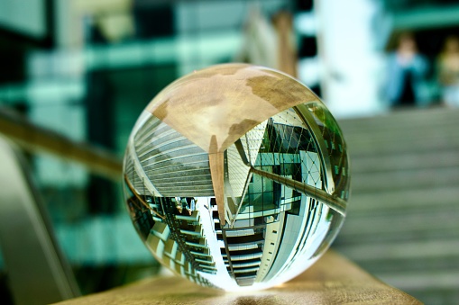Close up of crystal ball against skyscrapers