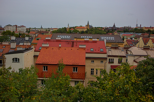 Panoramic view of the city of Prague from the observation deck. Streets and architecture of the old city. Romantic town panorama, historical buildings, red roofs, churches.