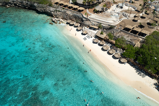Elevated view of Palapas and lounge chairs on Playa Kalki, Curacao