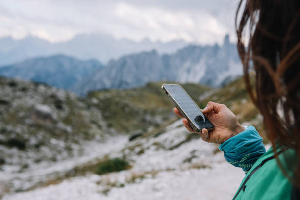 istock woman checking her location on top of Dolomites 1952927353