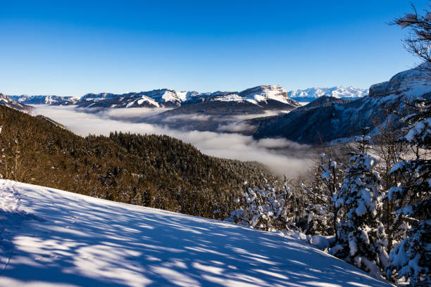 summit of dent de crolles from charmant som, in the chartreuse regional natural park, covered in snow above a sea of clouds - crolles imagens e fotografias de stock