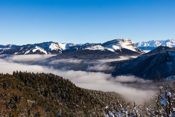 summit of dent de crolles from charmant som, in the chartreuse regional natural park, covered in snow above a sea of clouds - crolles imagens e fotografias de stock