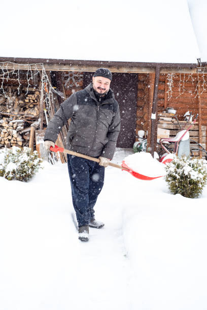 istock A man works removing snow with a shovel. 1952960798