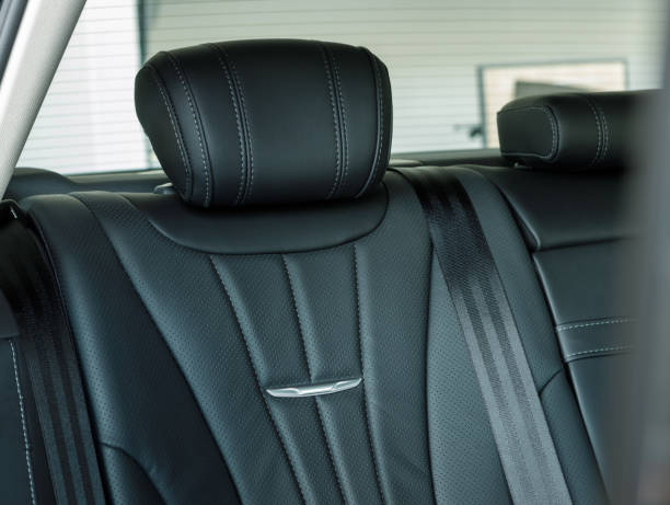 istock Back passenger seats in modern luxury car, frontal view, black leather 1952963451