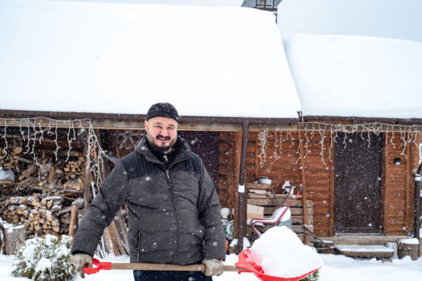 istock A man works removing snow with a shovel. 1952963456