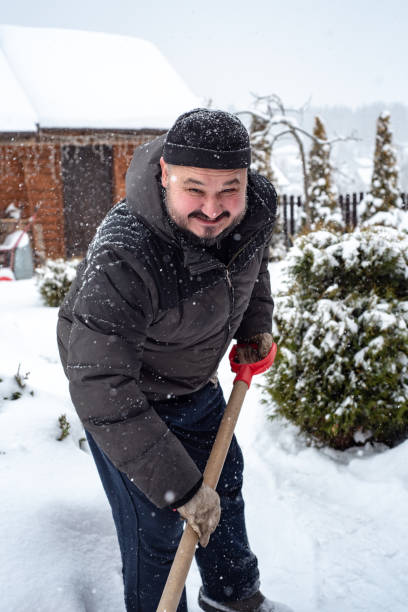 istock A man works removing snow with a shovel. 1952965090
