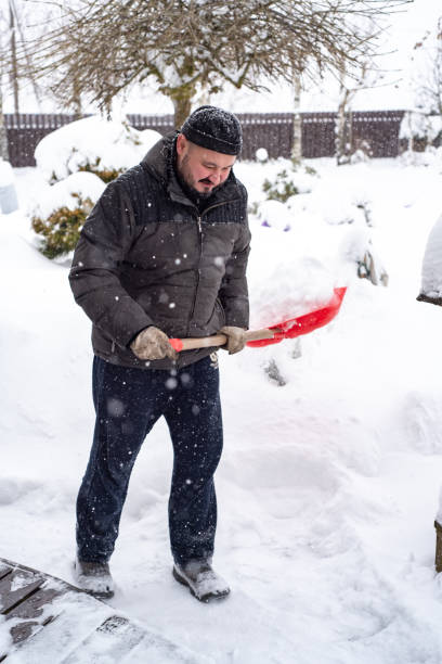 istock A man works removing snow with a shovel. 1952965094