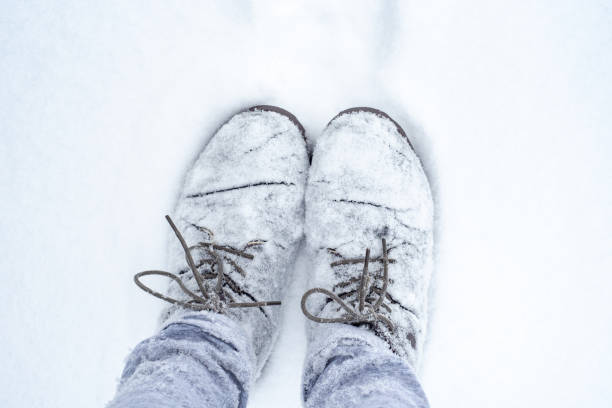 istock Boots in the snow, standing on a white background. 1952969663