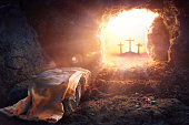 Resurrection Of Jesus Christ  - Empty Tomb -  Focus On Shroud And Defocused Crosses On Background With flare Lights Effects